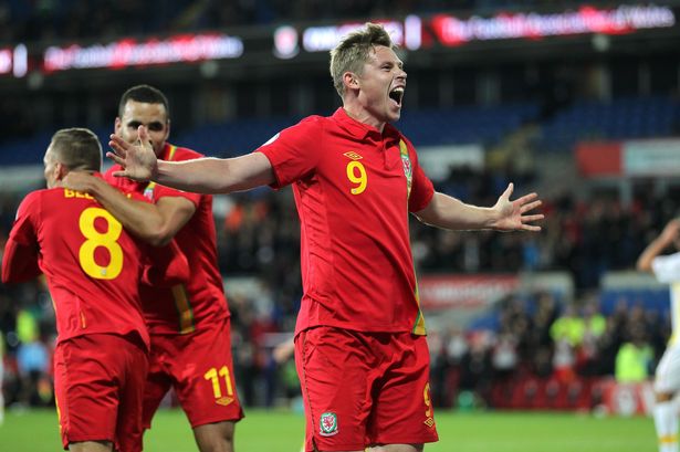 The presence of Craig Bellamy gives the club that this is a pretty old photo. it was taken in the aftermath of the only goal of a World Cup qualifier against Macedonia two and a half years ago and this remains Simon Church's only senior goal for Wales in a competitive match.*